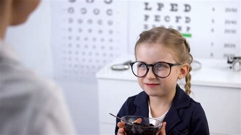 Ophthalmologist Giving Blueberries To Cute Little Girl, Natural Vitamin for Eyes Stock Photo ...