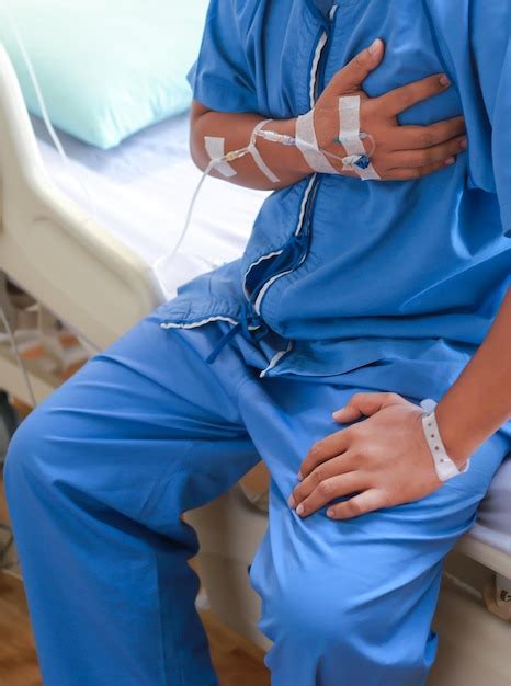 Premium Photo Midsection Of Man With Iv Drip On Bed In Hospital