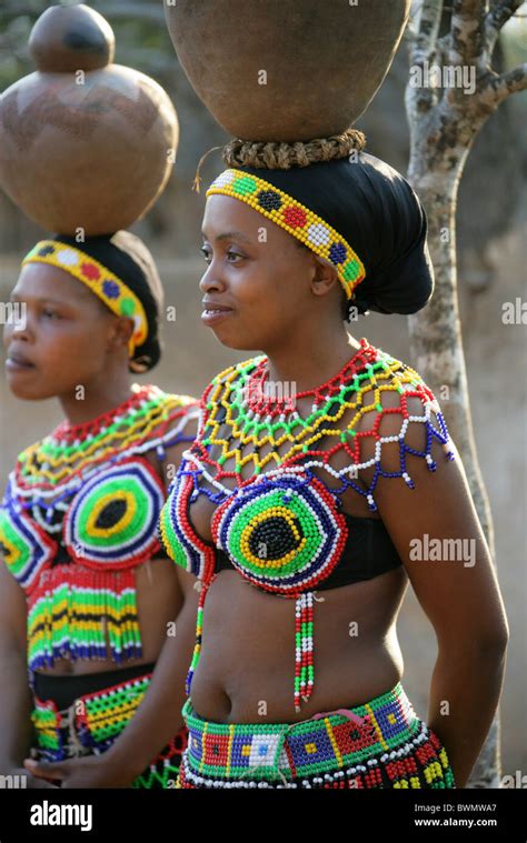 Zulu Girls Wearing Traditional Beaded Dress And Carrying Pots On Stock