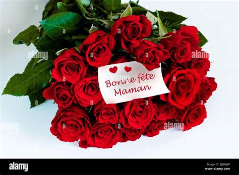 Bouquet Of Red Roses With Bonne Fête Maman Card In French Stock