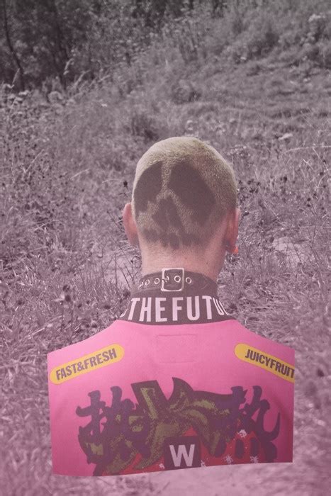 The Back Of A Man S Head With Graffiti On It Standing In A Field