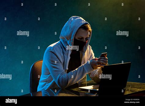 Hooded Computer Hacker Stealing Information With Laptop Stock Photo Alamy