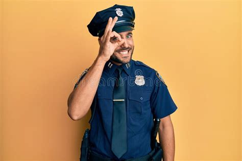 Handsome Hispanic Man Wearing Police Uniform Doing Ok Gesture With Hand