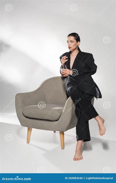 Barefoot Woman in Stylish Suit Holding Stock Photo - Image of grey, barefoot: 260883646