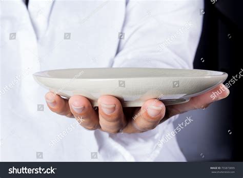 Hands Holding Empty Plates Front Stock Photo Edit Now