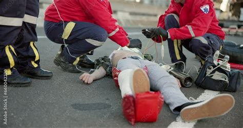 Emergency Ambulance And People On Road For Injury Accident And Car