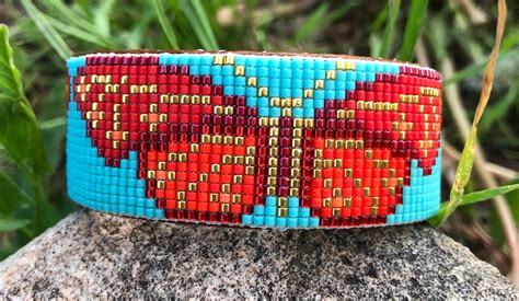 Beaded Butterfly Bracelet In Shades Of Reds And Gold On A Turquoise