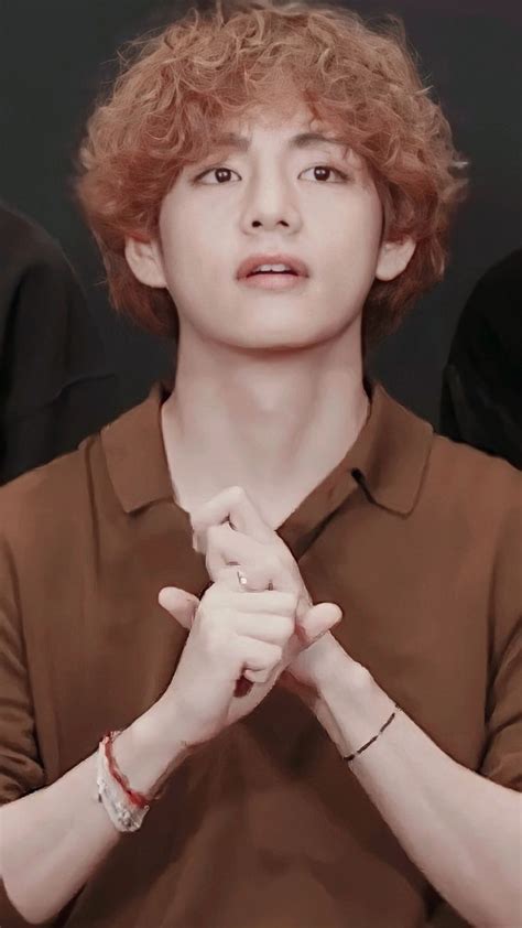 A Man With Red Hair Holding His Hands Together