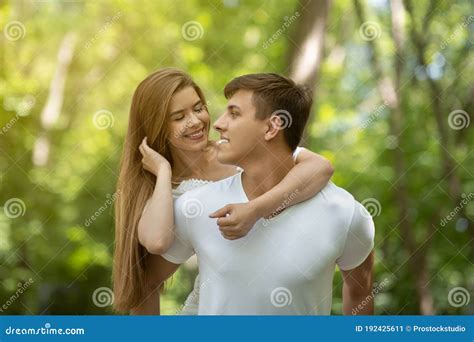 Romantic Millennial Couple Looking At Each Other Lovingly At Summer