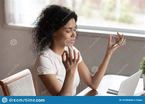 Mindful African Ethnicity Woman Freelancer Relaxing With Closed Eyes