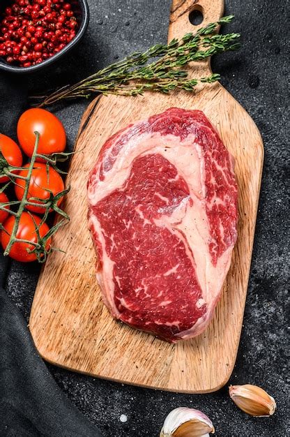 Premium Photo Raw Fresh Meat Ribeye Steak With Seasoning On Cutting