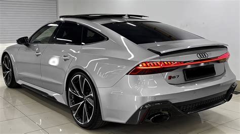 The Rear End Of A White Car Parked In A Garage