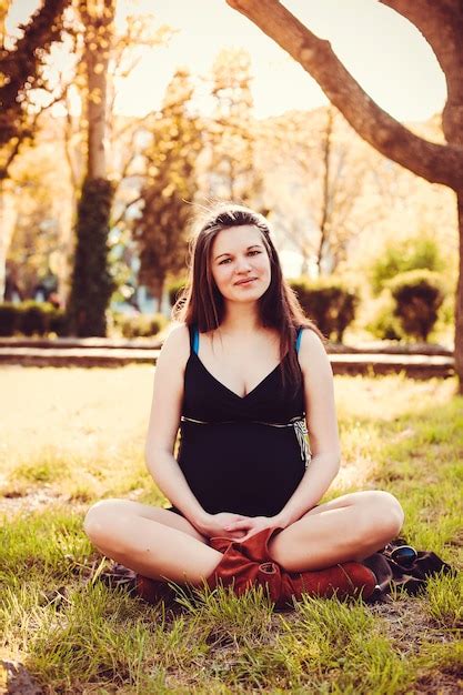 Premium Photo Pregnant Woman Stands Next To The Sunset In The Garden