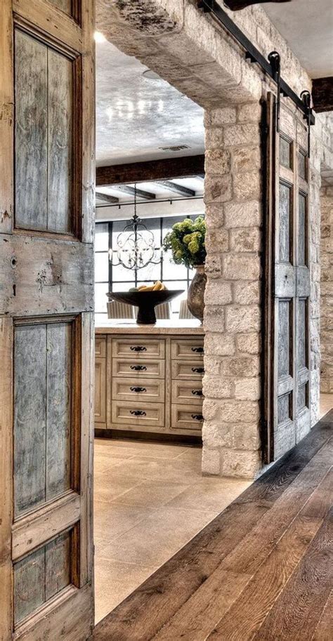 An Open Door Leading To A Kitchen With Stone Walls And Flooring On The Side