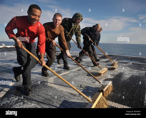 Pacific Ocean Dec 11 2013 —sailors Scrub The Flight Deck Of The