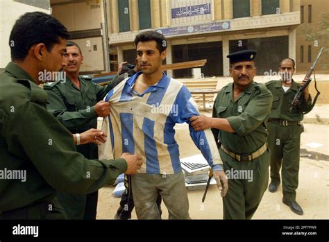 Iraqi Police Officers Arrest A Looter At The National Assembly Compound