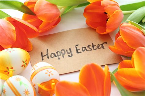 Happy Easter Egg Text With Brown Print Paper Surrounded Of Orange Tulip