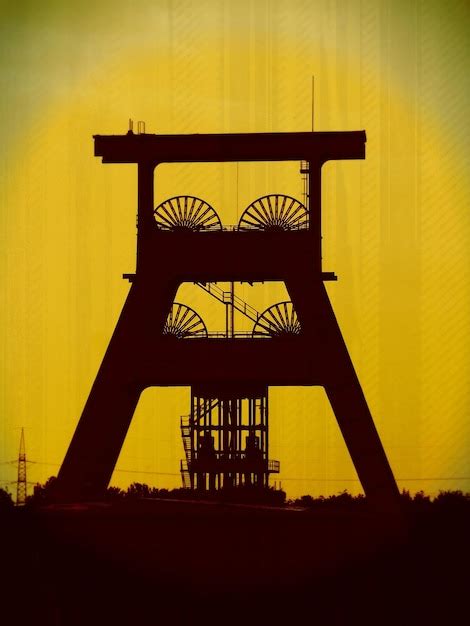 Premium Photo | Silhouette factory against yellow sky at sunset