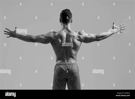 Back View Of Athletic Shirtless Guy Demonstrating Well Trained Body