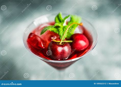 Cherry Cocktail In Martini Glass With Berries And Mint Leaves Stock