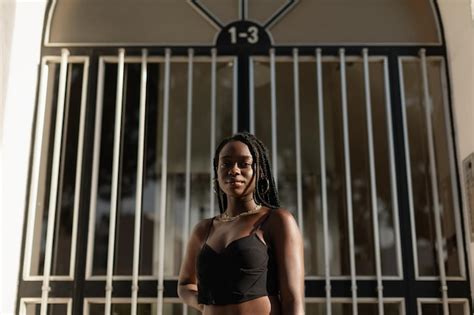 Retrato De Una Joven Negra Posando Frente A Una Puerta Durante Una