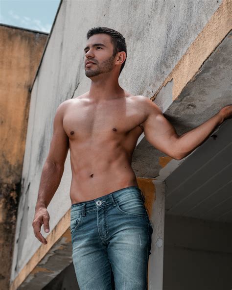 Shirtless Man Standing Near Weathered Building · Free Stock Photo