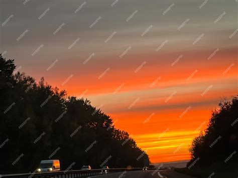 Premium Photo | Beautiful sunset over the road for cars (car track at sunset, in the evening)