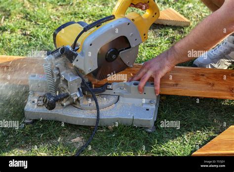 A Worker Saw Wood With A Chop Saw Stock Photo Alamy