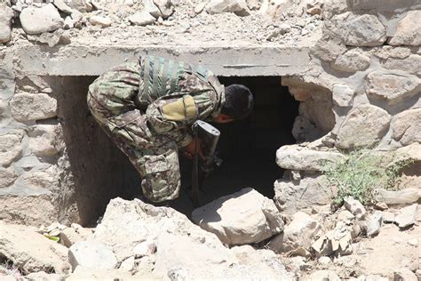 An Afghan National Army Soldier Checks A Culvert On Nara And Dvids