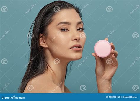 Headshot Portrait Of Asian Girl Holding Round Cream Jar Stock Image