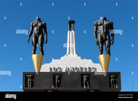 The Olympic Gateway Arch And Male And Female Statues At The Entrance To