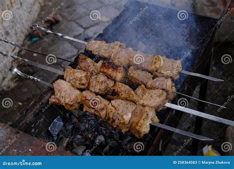 A Man Roasts Meat On A Fire Close Up Of Hands And Shish Kebab Cooking