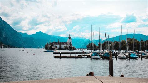 Calm Lake With The Big Mountains And The Schloss Ort Castle In The