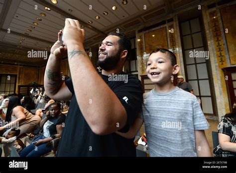 L R Joshua Santiago And His Son Jesse Santiago 5 Look On As Mrs