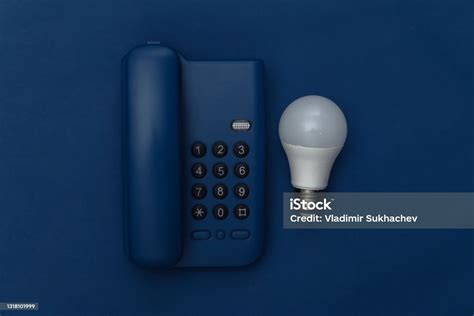 Landline Phone With Light Bulb On Classic Blue Background Color 2020 ...