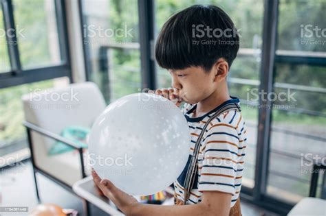 Boy Inflates Balloon Stock Photo Download Image Now Asian And