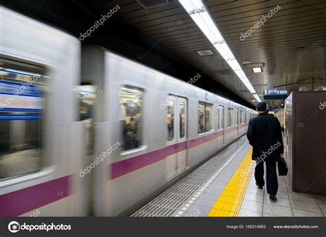 Interior of a Tokyo subway station and platform with subway comm ...