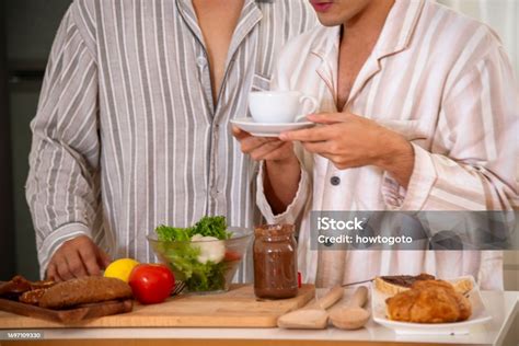 Happy Gay Couple Enjoy Breakfast In Kitchen Drinking Coffee Two Best Friends Lgbtq Relation