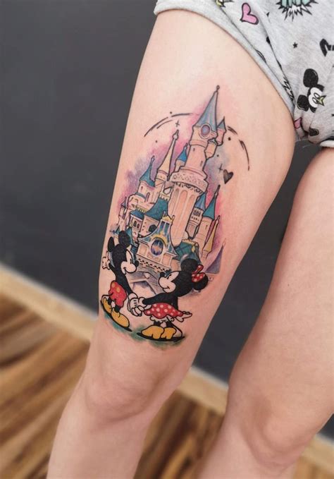 A Woman S Leg With A Tattoo Of Mickey Mouse And Castle On The Side