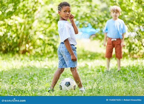 Two Boys are Playing Football in the Park Stock Image - Image of soccer ...