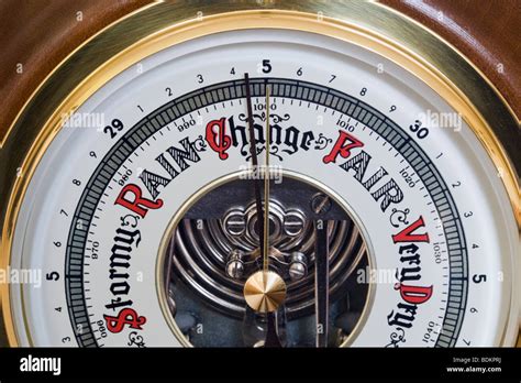 Classic Aneroid Barometer Made From Wood And Brass With Needle Pointing