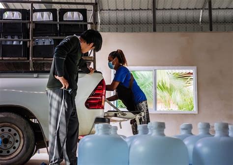 Trabalhadores Do Trabalho Em Equipe Colocam Gal Es De Garrafas De Gua