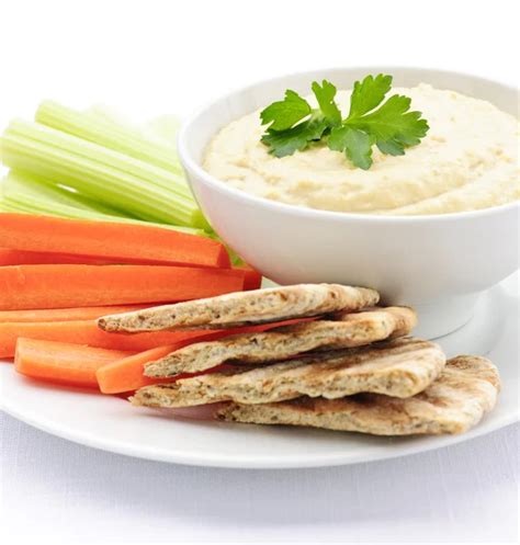 Hummus with pita bread and vegetables — Stock Photo © elenathewise #4467641