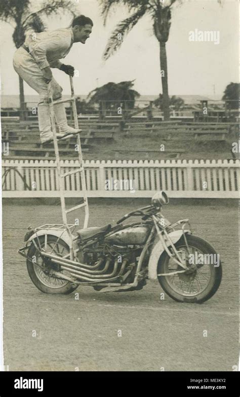 Performing a stunt on a motorcycle Stock Photo - Alamy