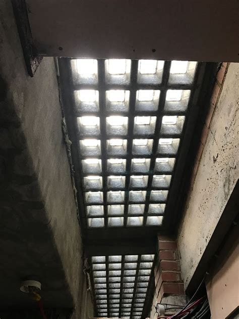 The Inside Of An Abandoned Building With Sunlight Coming Through The Roof