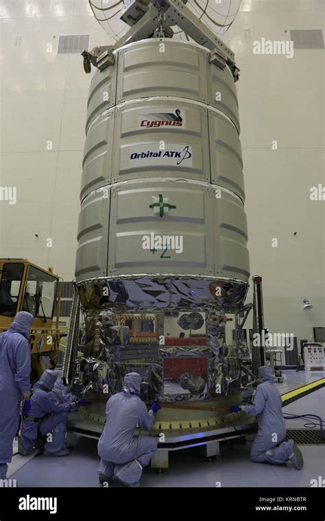 Technicians Assist As A Crane Lowers Orbital Atk S Cygnus Pressurized