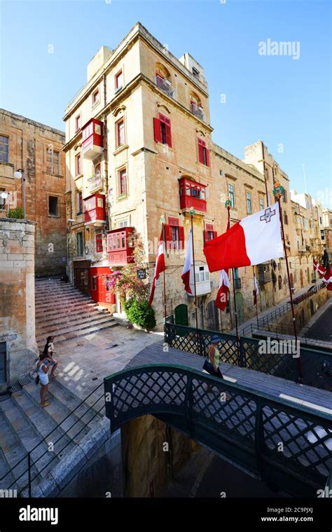 The Colorful Building With The Red Balconies Above The Victoria Gate In