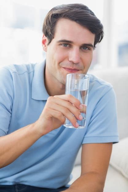 Premium Photo Portrait Of A Man Holding A Glass Of Water