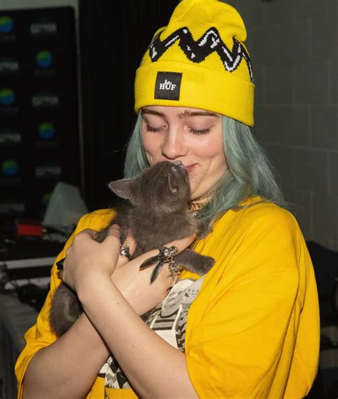 Billie Eilish Holds A Kitten From Motley Zoo During Deck The Hall