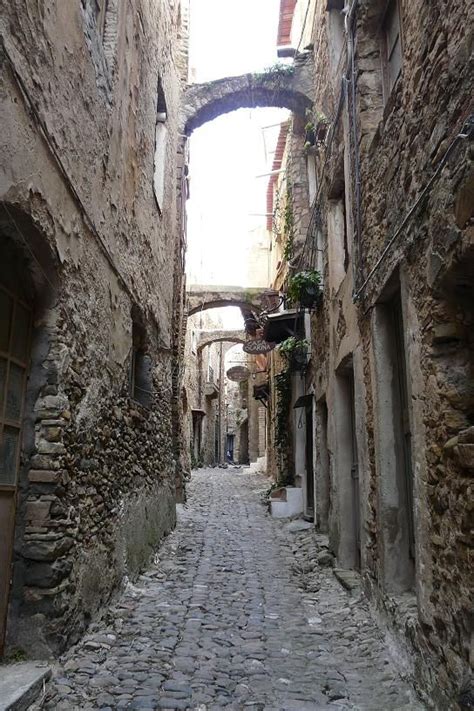 An Alley Way With Stone Buildings And Cobblestones